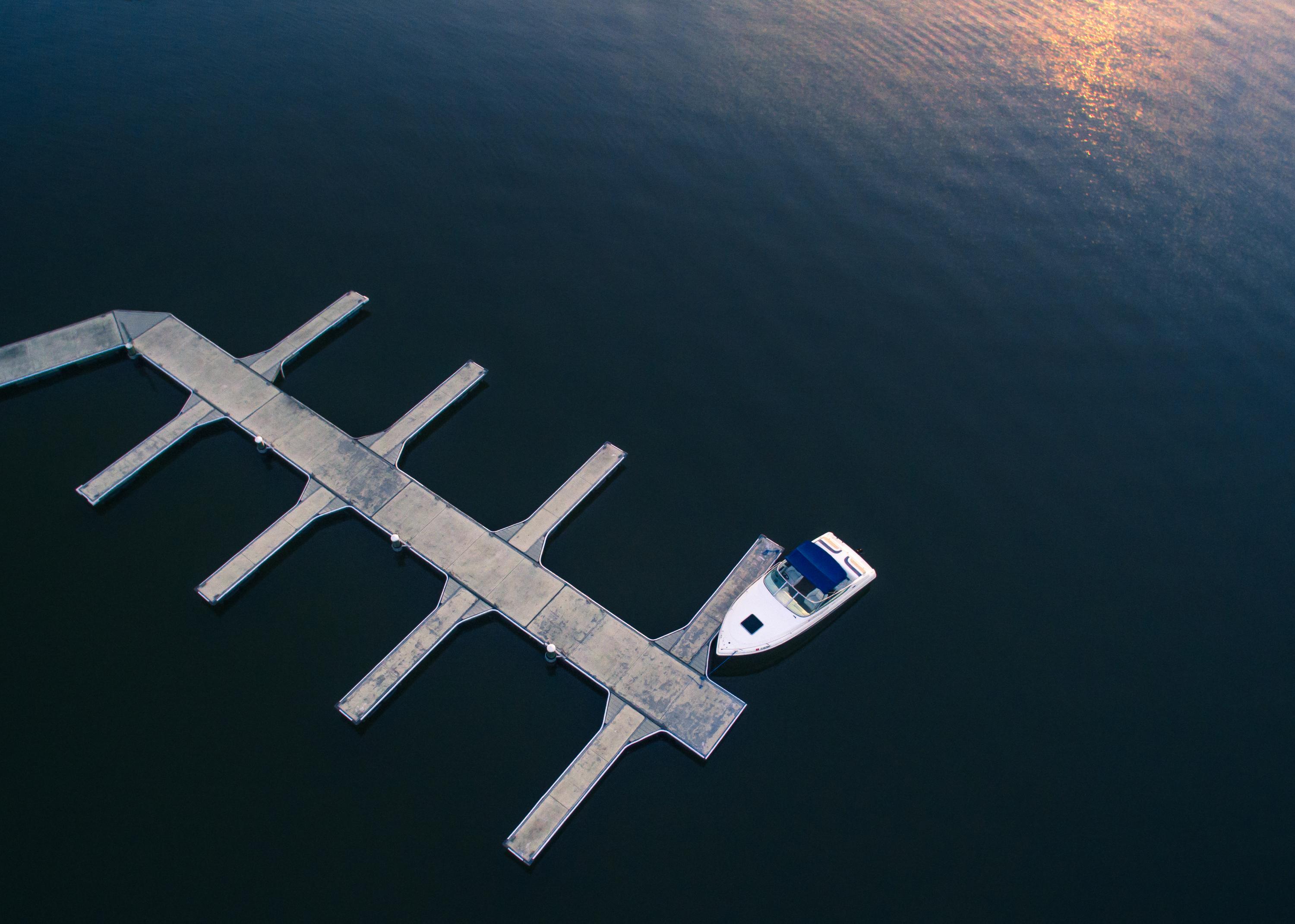 Aerial view of a dock and marina on a calm lake at sunset in Lake County, Florida, capturing the chain-of-lakes lifestyle that defines this Central Florida county
